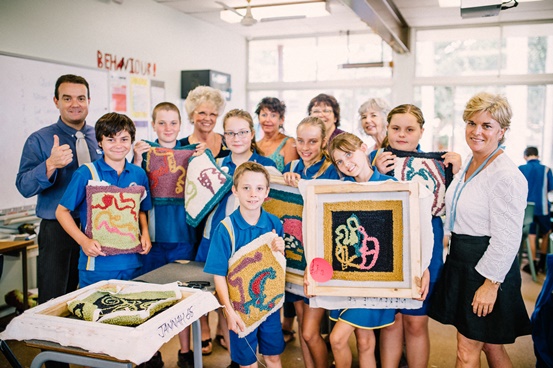 Photo of students with their artwork from the project